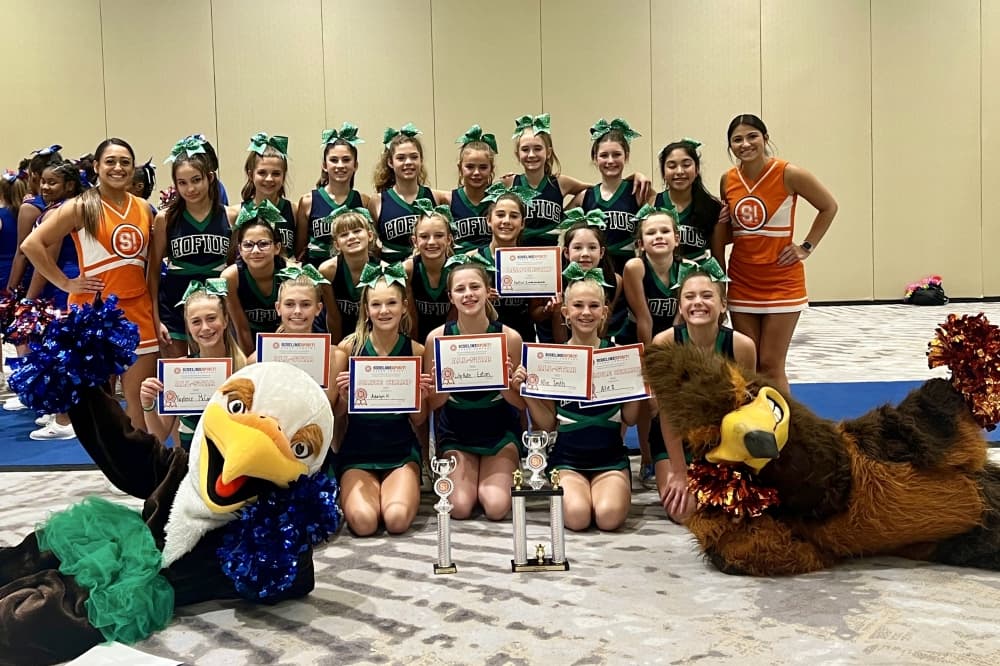 Group photo with Sideline Cheerleaders with green bows