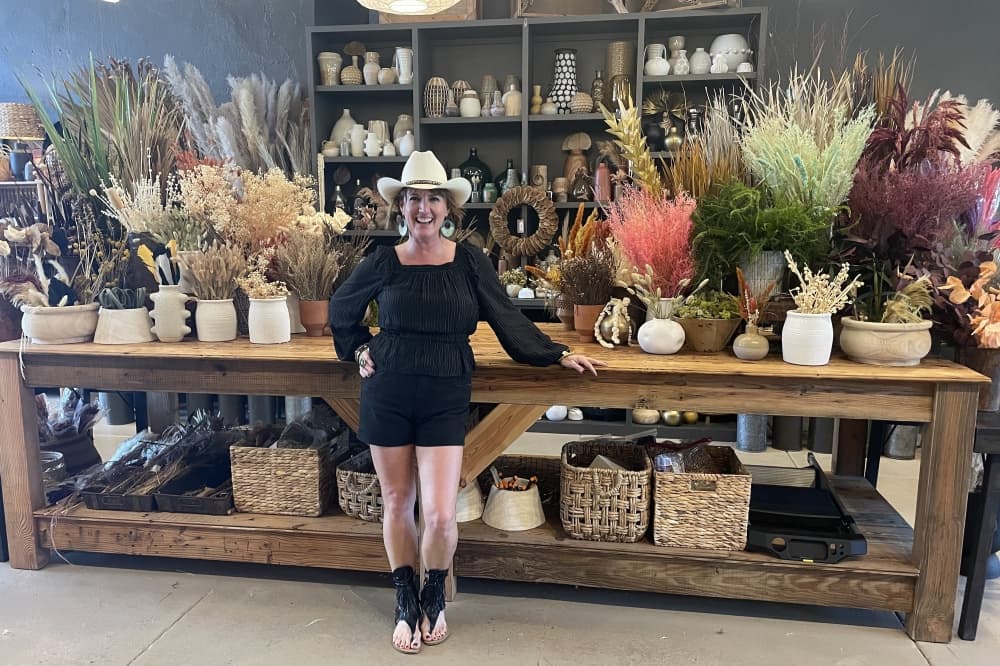Traci Miller stands in front of her 12-foot long botanical bar station