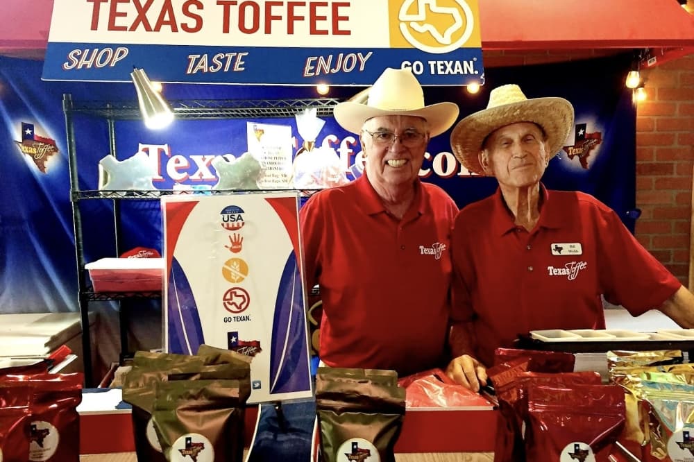 Texas Toffee employees posed behind their State Fair of Texas booth in Dallas