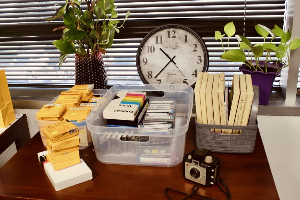 Orders and clock with plants in background