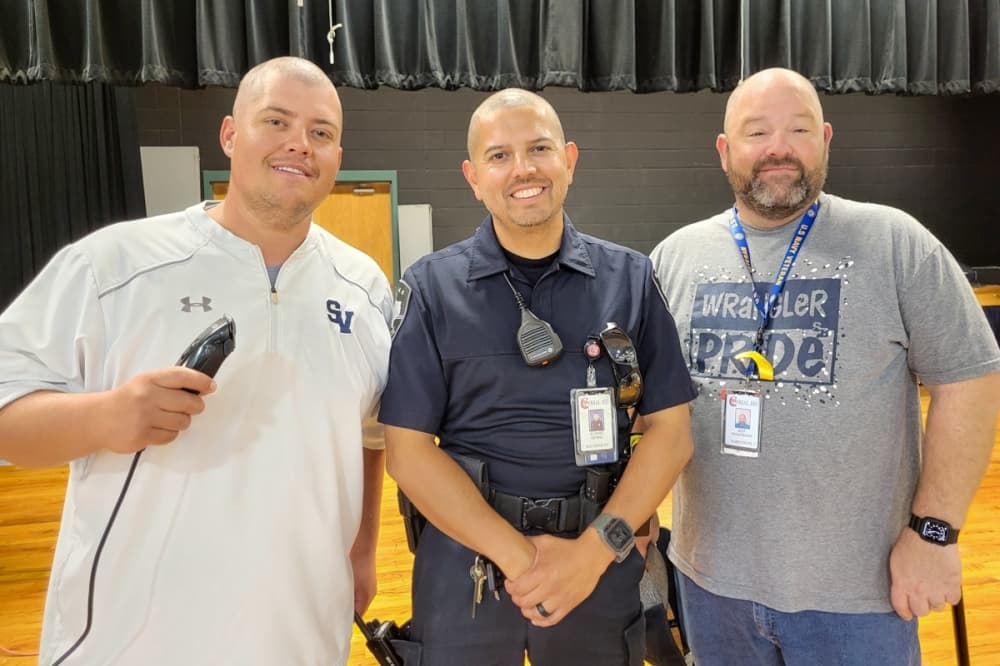 Three Comal ISD staff that had their heads shaved by students during lunch to raise funds