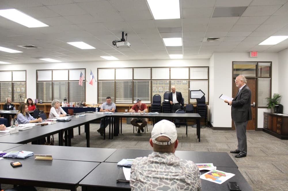 The photo shows David Thompson of Thompson & Horton LLP and Montgomery ISD trustees.
