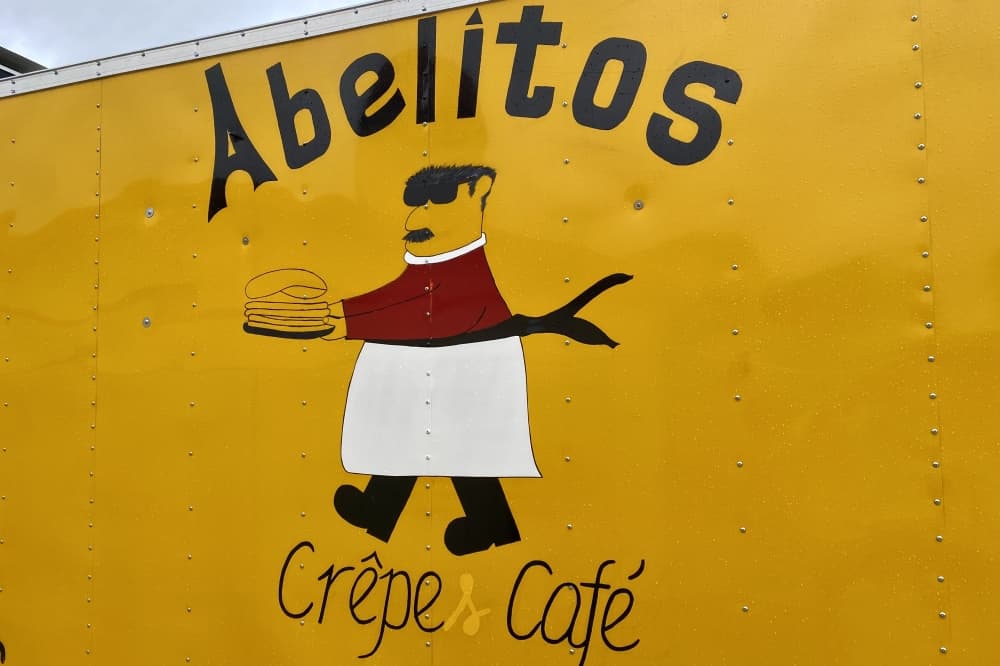 A photo of a drawn man with crepes on Abuelitos food truck.