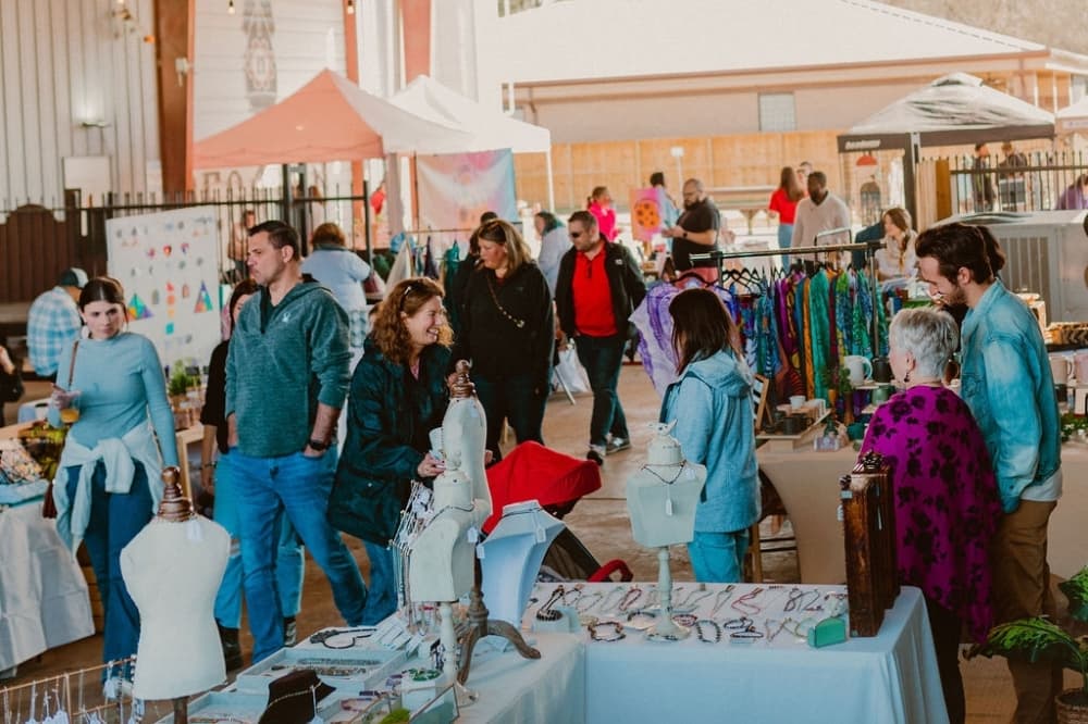 People at market with tents 