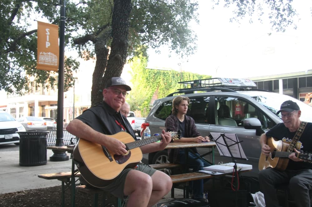 Two men playing guitars.