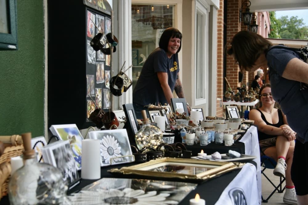 A woman selling at a table.