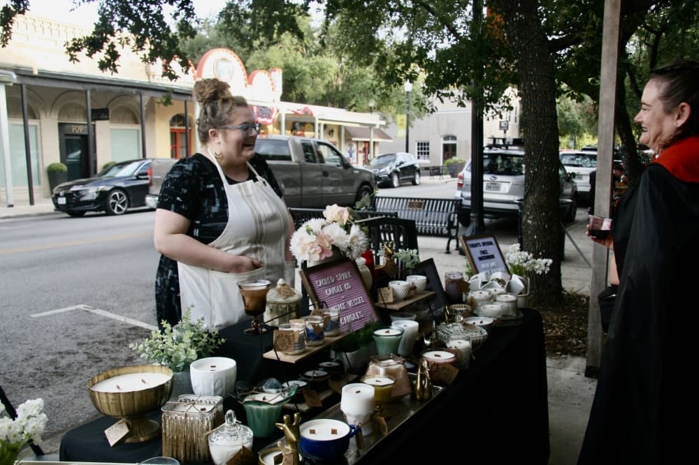 A woman selling candles at Bastrop Artwalk.