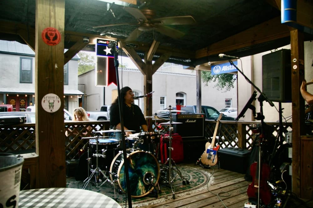 A drummer at an outdoor stage.