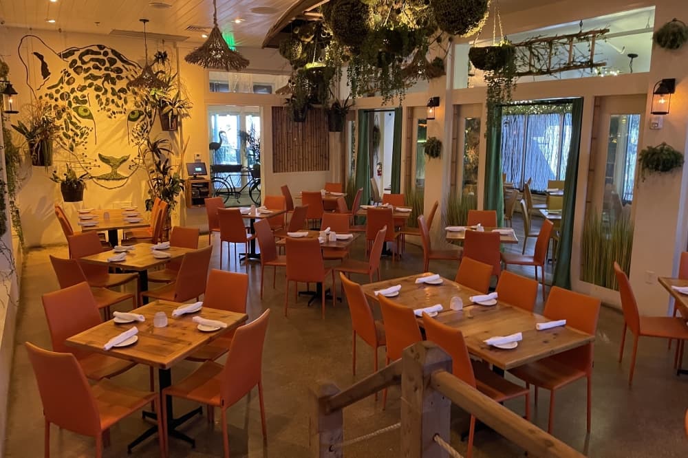 Jungle Lodge dining room at Lost Colony with a tiger mural made of moss