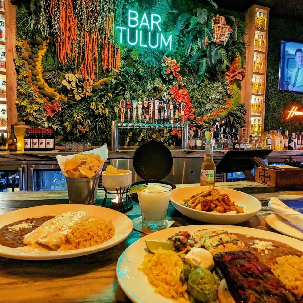 Chips and queso, steak and chicken fajitas, and sour cream chicken enchiladas at Bar Tulum. 