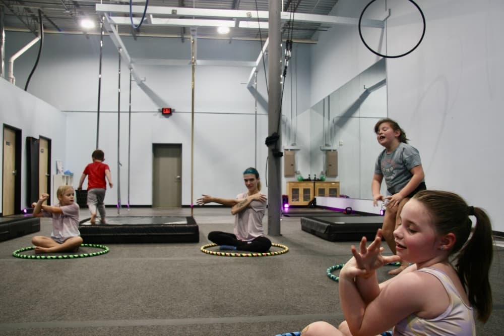 Children stretch in a studio class.