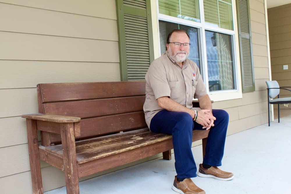 Executive Director David Maulsby sitting on bench