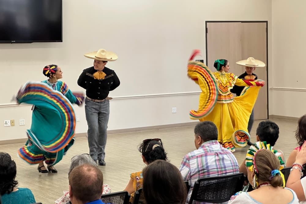 The photo shows members of Mixteco Ballet Folklórico dancing.