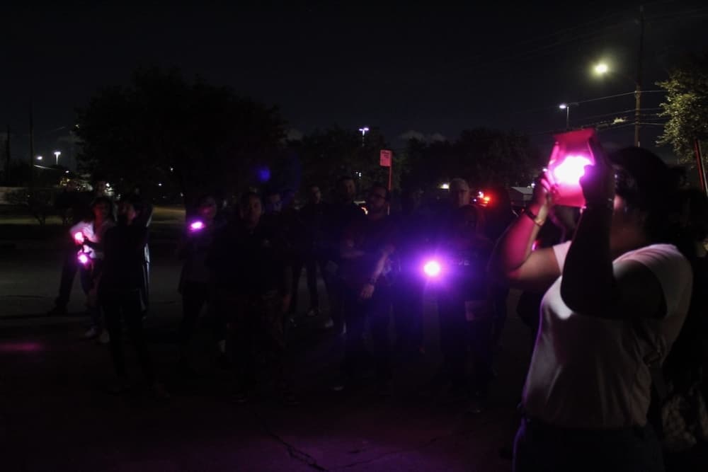 This is a picture of people in the dark using lighting objects.