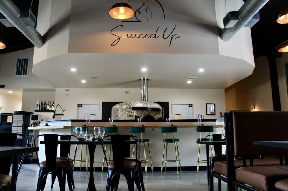 Dining area with Sauce Up sign 
