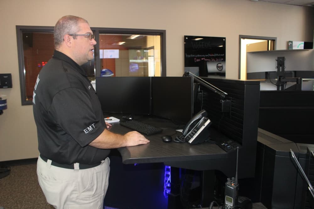 Jason Millsaps stands at one of the main desks in the command center.