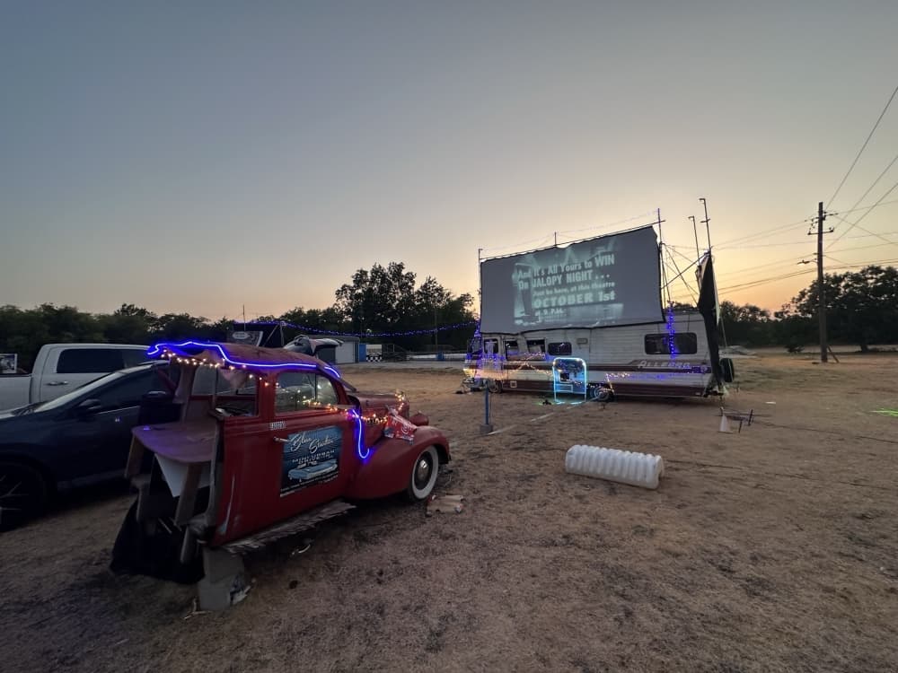 A drive-in theater is pictured at sunset.