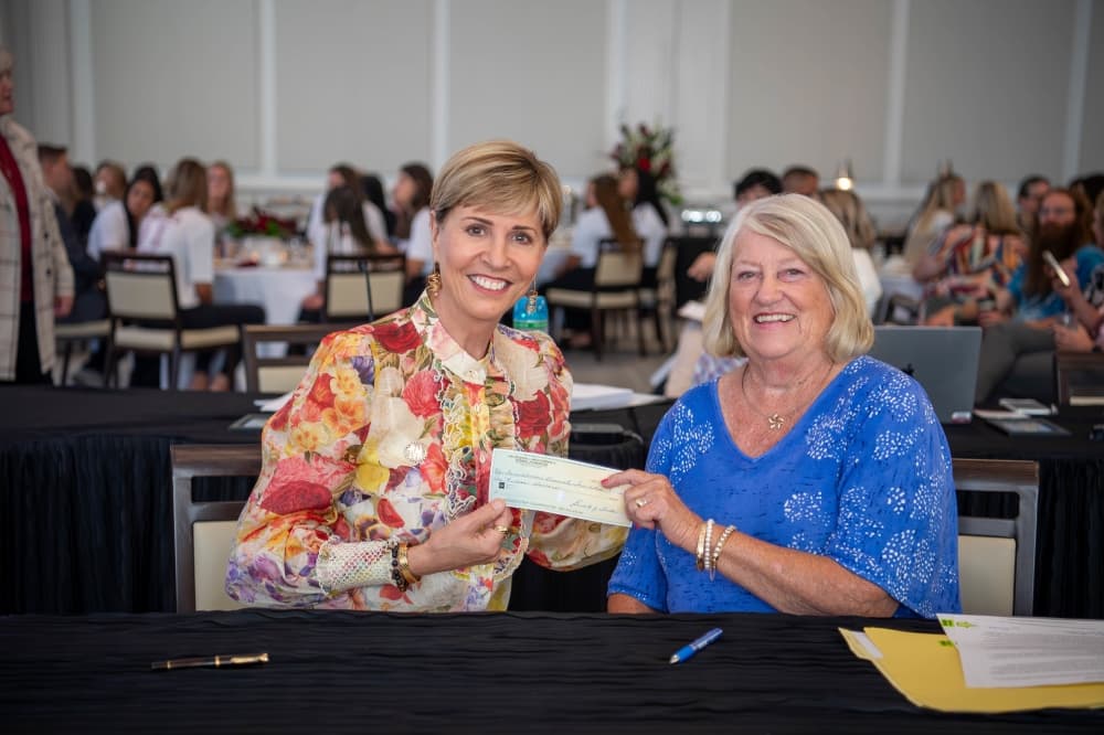 Two women posed with the check from the foundation. 