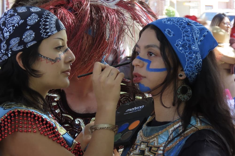 Girls paint each others faces at Plano International Festival. 