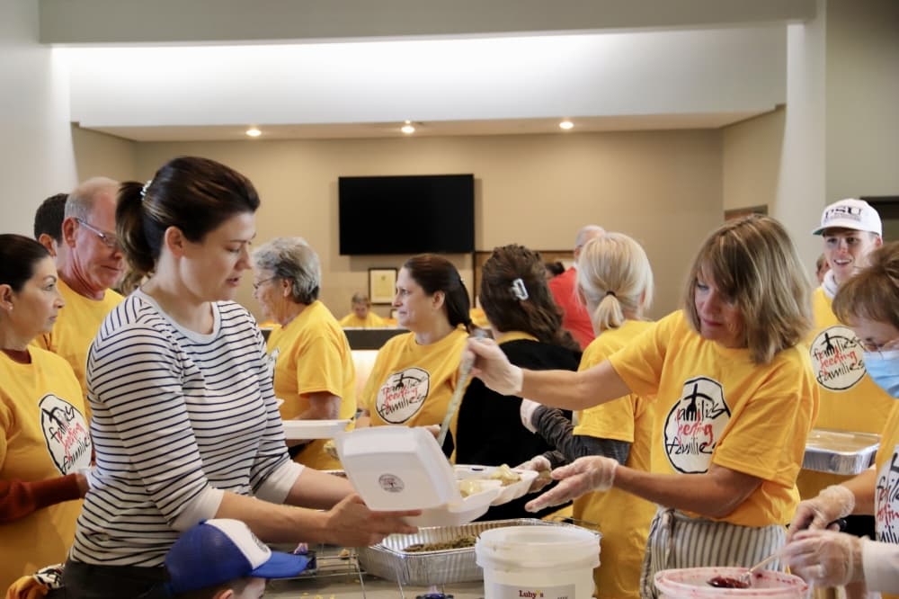 People serving families food