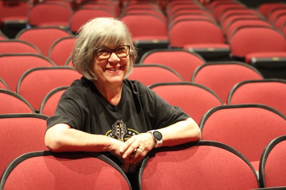 Cheryl Fisher sits in theater seats
