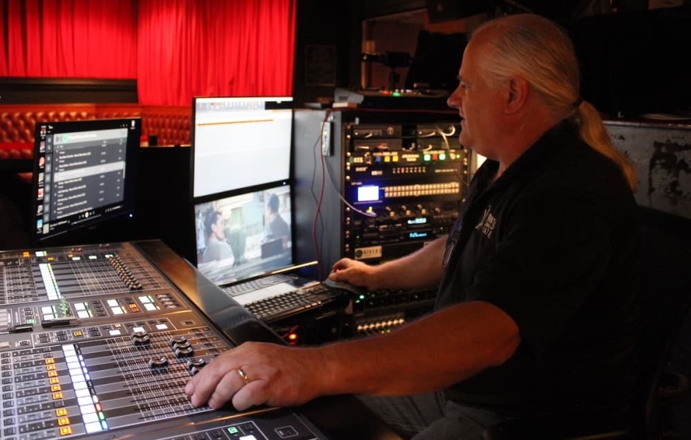 Carl Nowotny adjusts the sound and prepares for an evening show. 