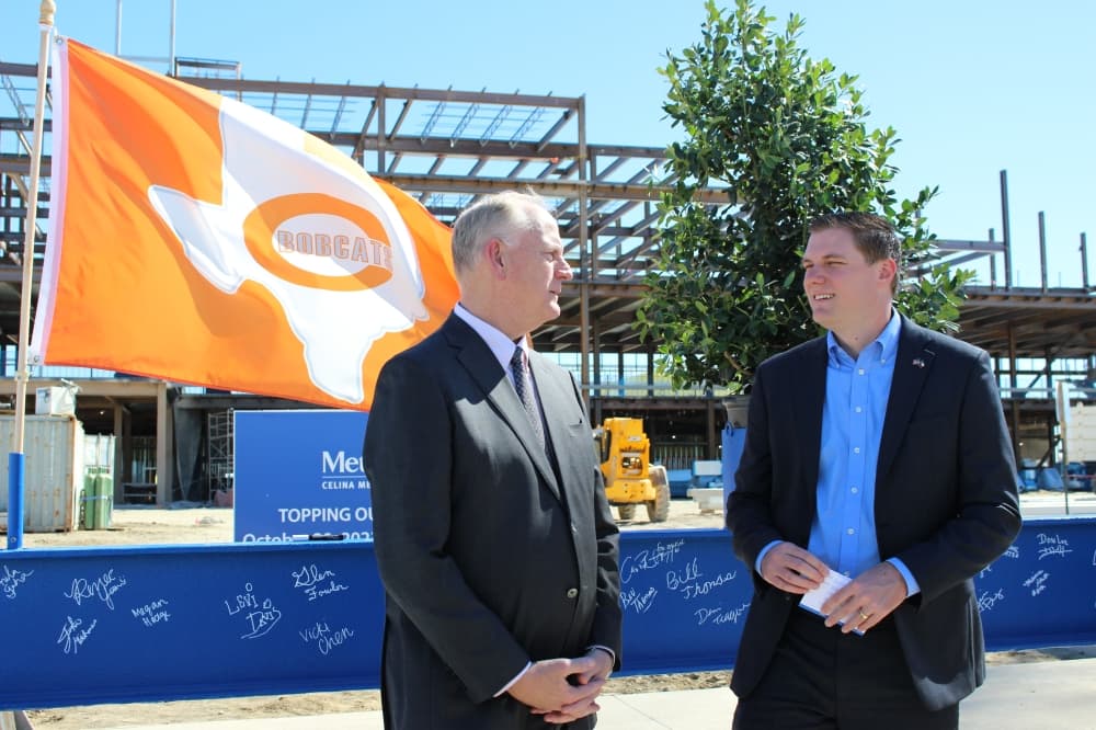 ryan tubbs and james scoggin stand in front of the blue beam