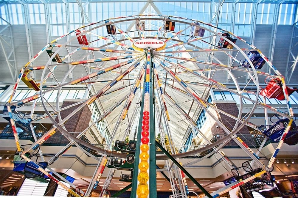 A Ferris Wheel stands inside a building.