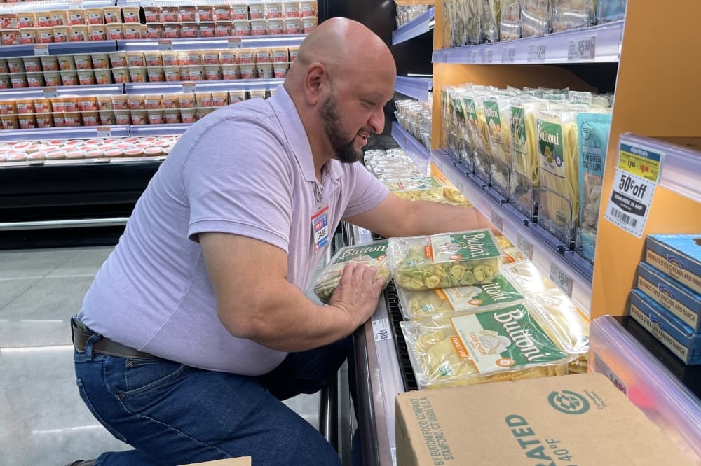 An H-E-B employee stacks shelves at the new H-E-B in Manvel, Texas