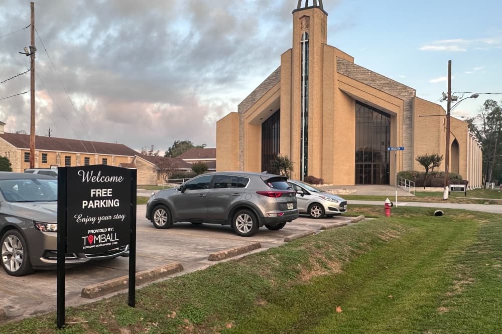 The Tomball Economic Development Corp. has put up signs around the parking lots at First Baptist Church, which it purchased in April. (Lizzy Spangler/Community Impact)