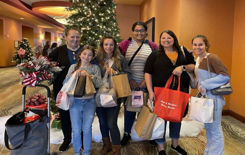 Shoppers at Angels & Mistletoe Holiday Market