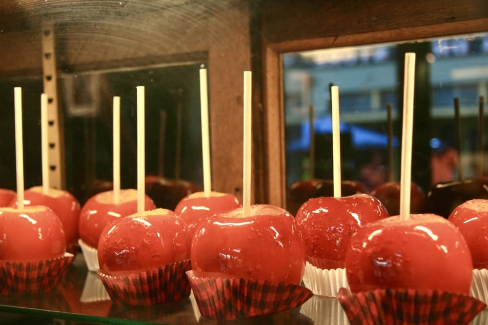 Candied apples behind a glass case.