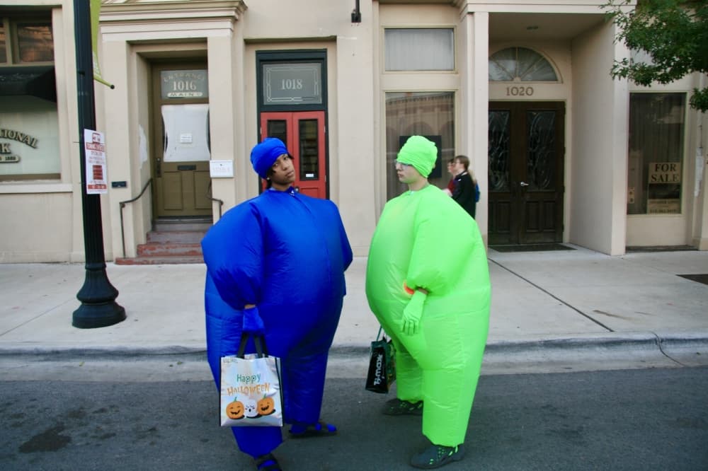 Two boys pose in inflatable suits.