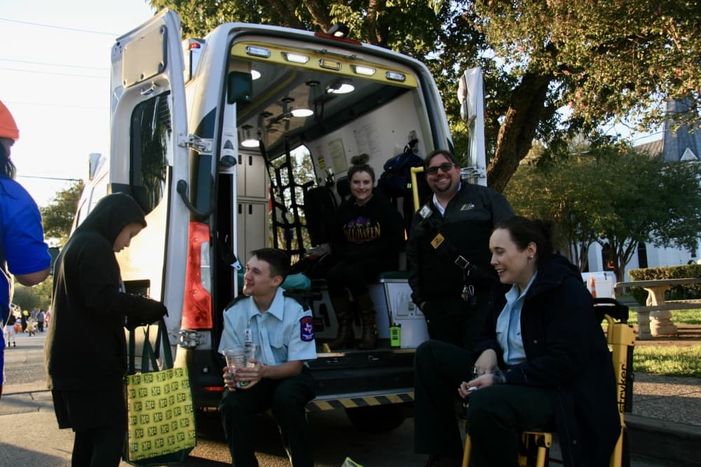 EMTs smile and hand out candy.