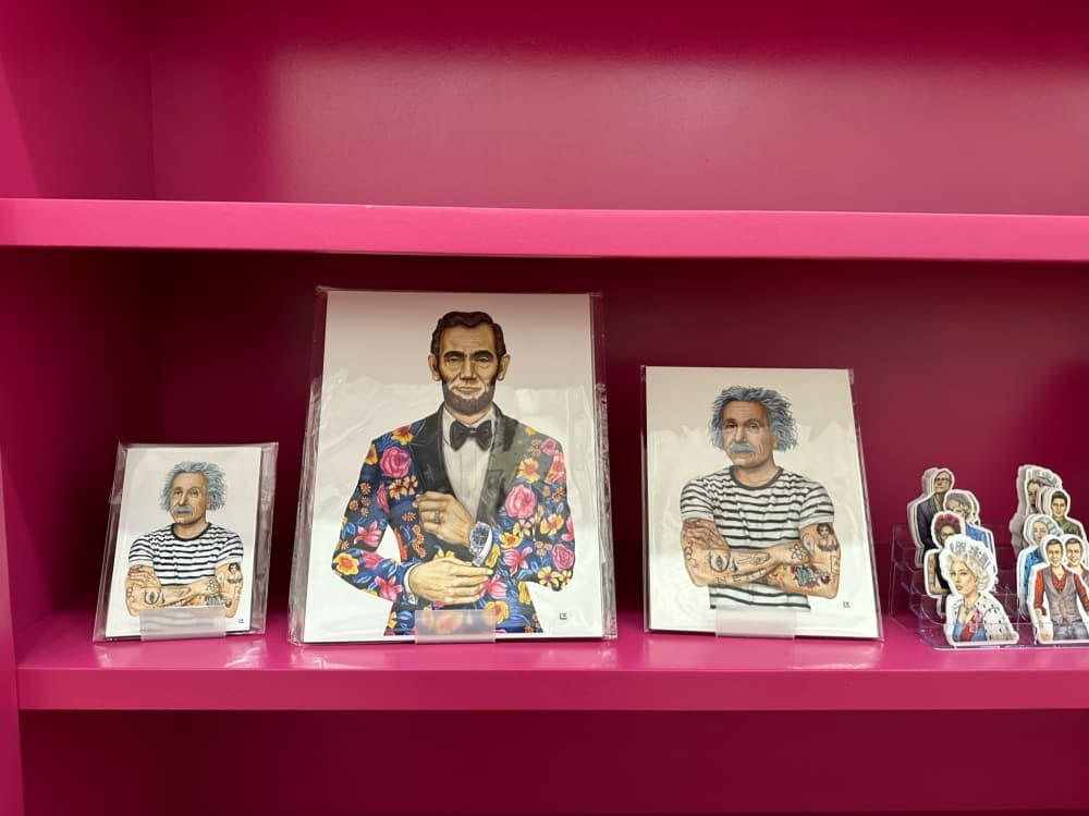 Art prints and stickers on a shelf