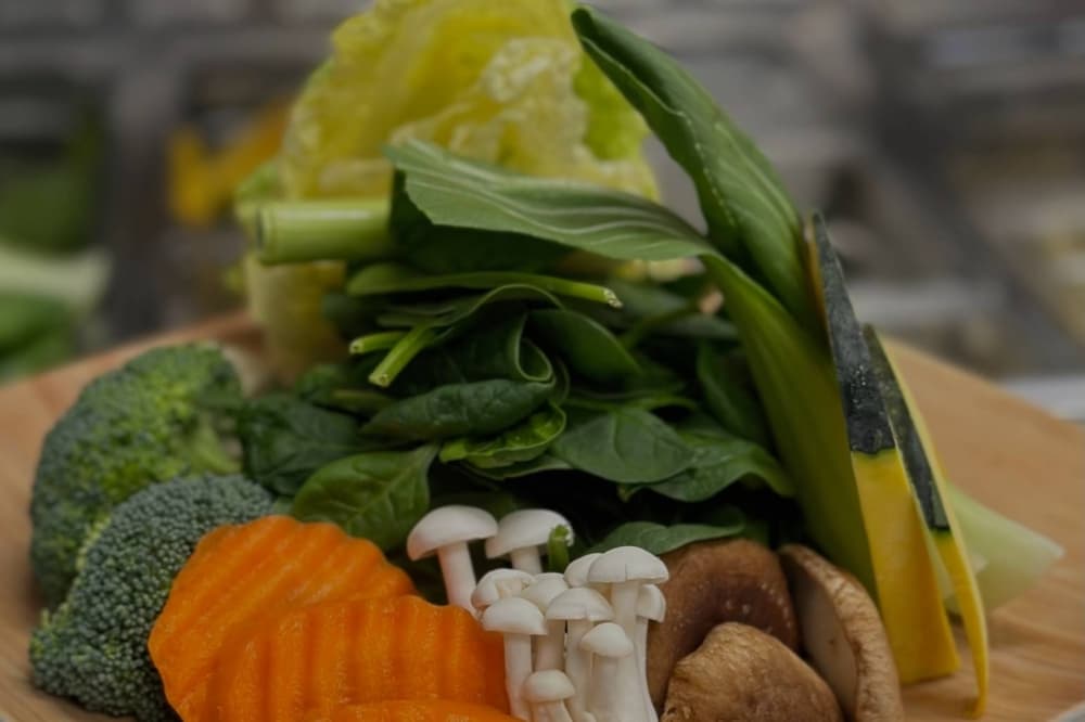 Vegetable plate featuring carrots, broccoli, mushrooms and more.