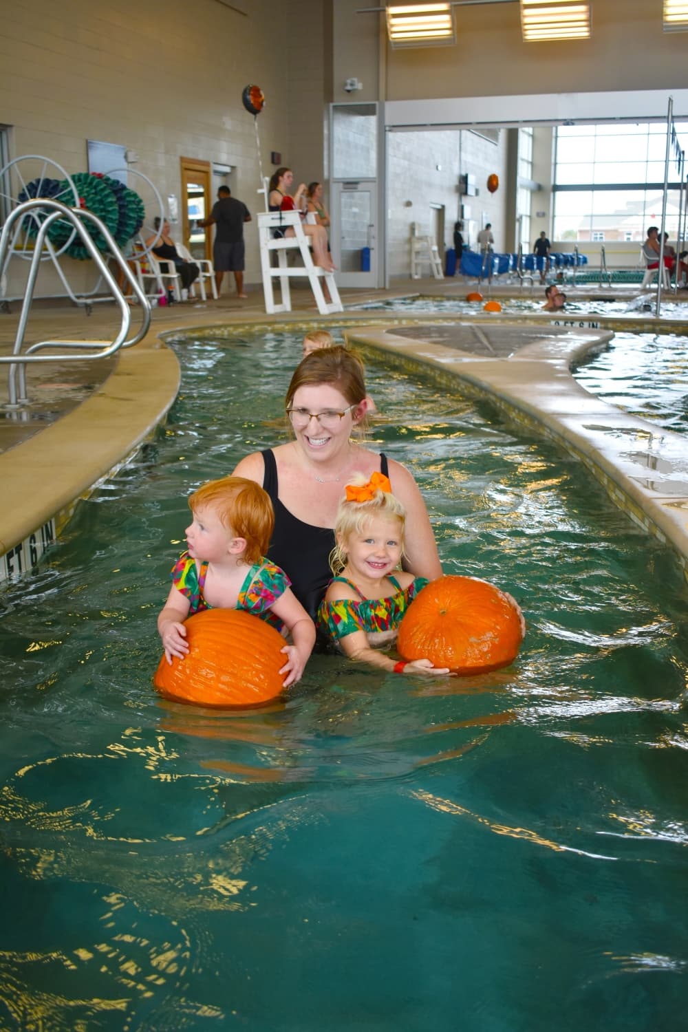 People swimming with pumpkins