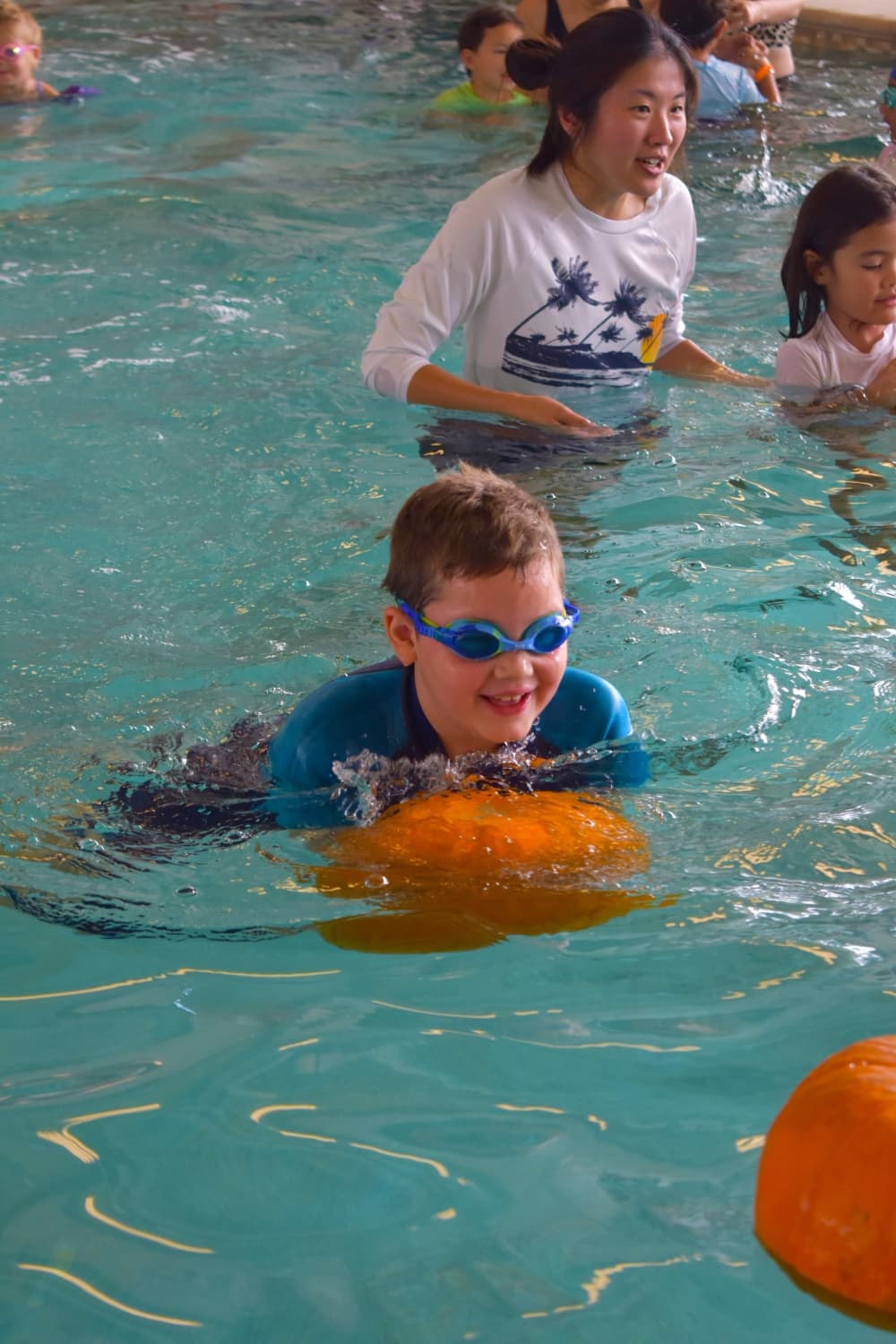 People swimming with pumpkins