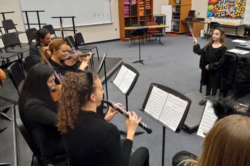 Kid conducting an orchestra
