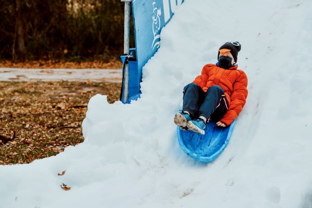 kid sledding down