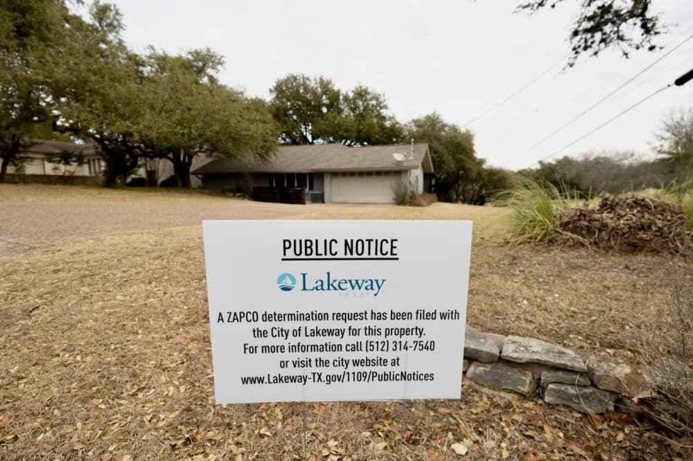 a public notice sign in front of a home