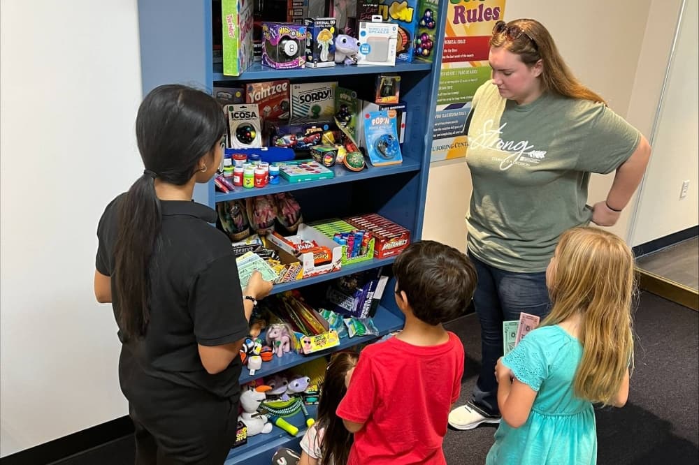 students buying toys. 