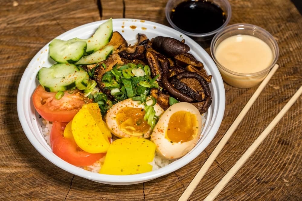 vegetables and a soft-boiled egg cut in two