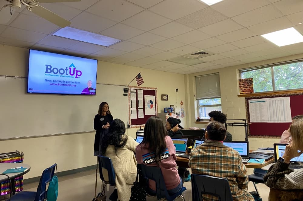A woman leads a lesson in front of teachers in a classroom.