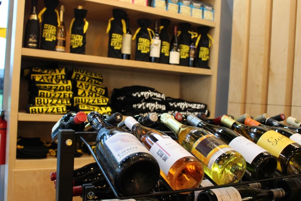bottles of wine in the foreground with merchandise in the background