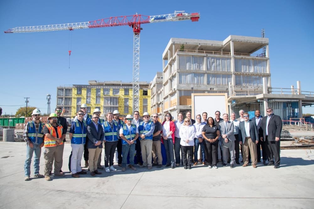 Group of people in front of a building under construction