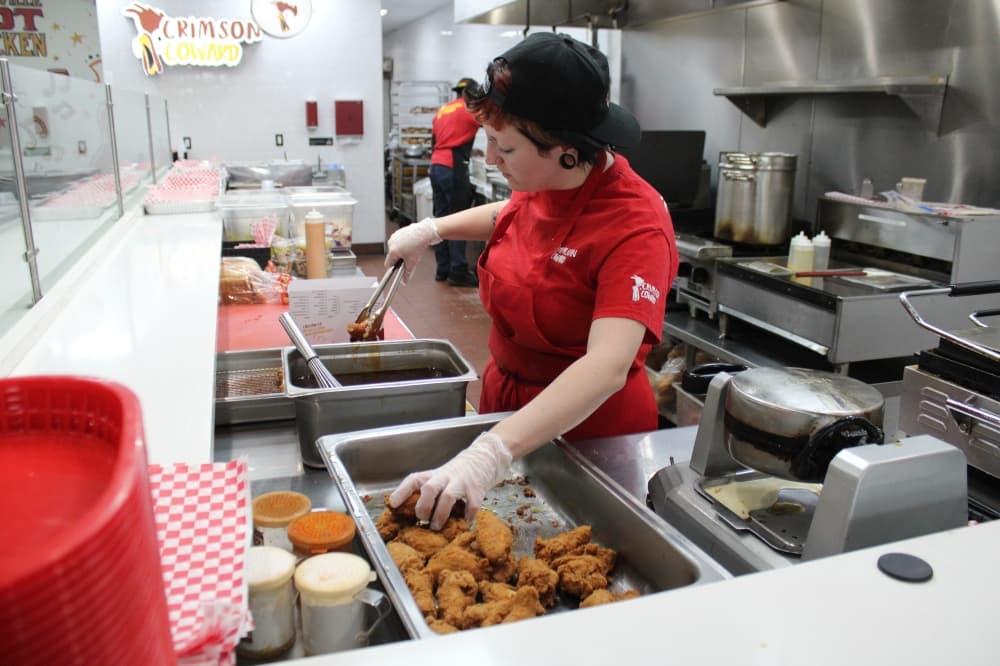 A cook preps food at Crimson Coward. 
