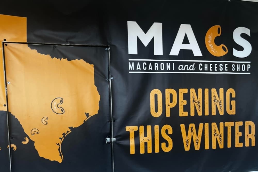 A sign denoting a new macaroni restaurant coming in the winter to Kalahari Resorts. 