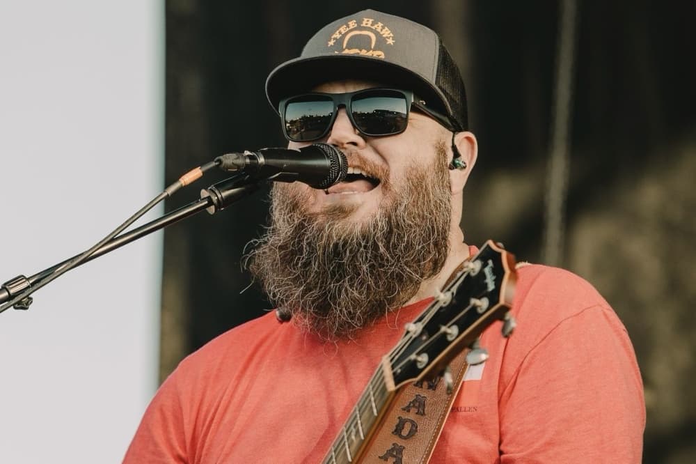 Bearded singer with hat and guitar
