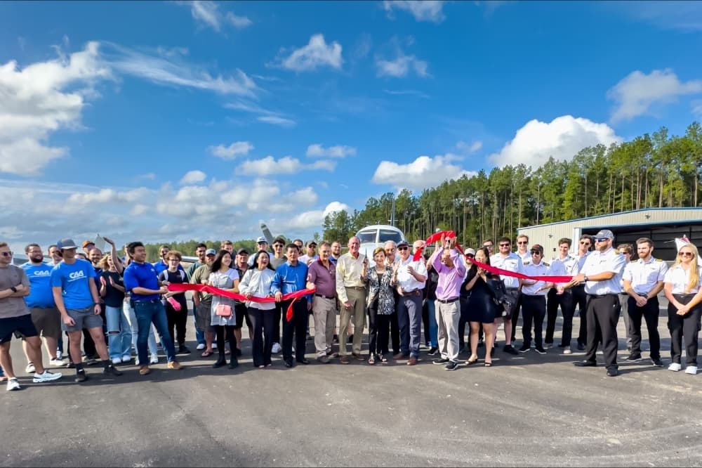 Chennault Aviation Academy officials cutting the ribbon to commemorate the opening of the airfield.